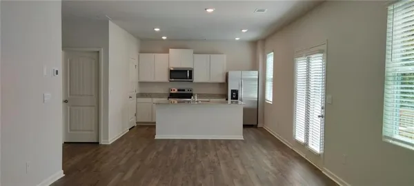 a kitchen with stainless steel appliances a refrigerator and a stove top oven