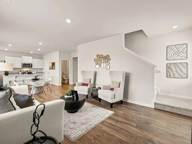 a living room with furniture and view of kitchen