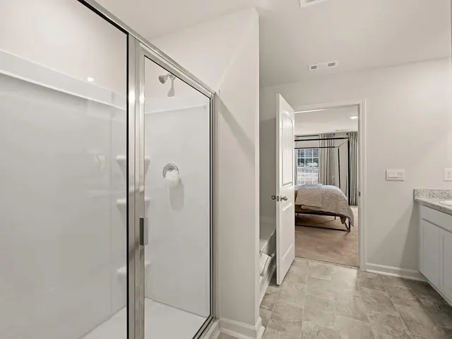 a en suite bathroom with a shower and a glass door