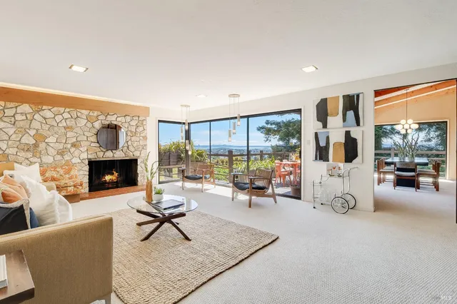 a living room with furniture a fireplace and a table