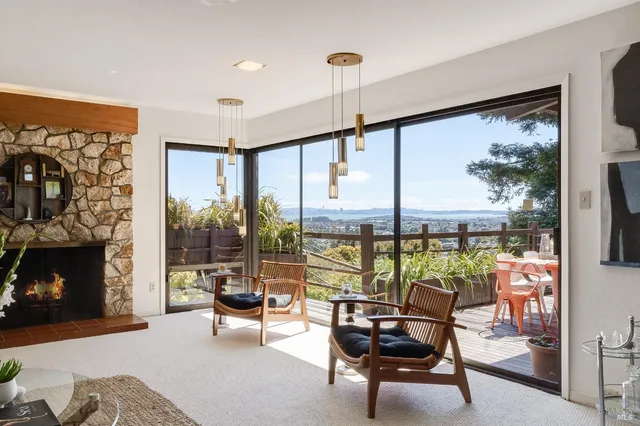a living room with furniture gym equipment and a large window