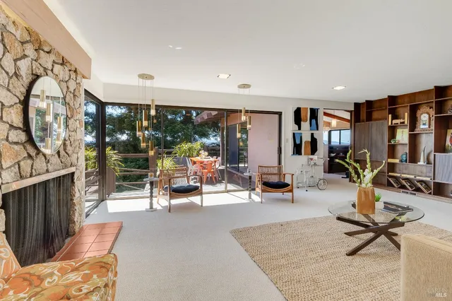 a dining room with furniture and large windows