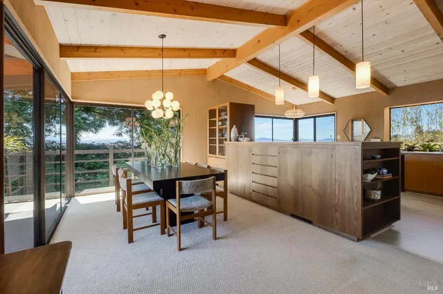 a dining room with furniture window and outside view