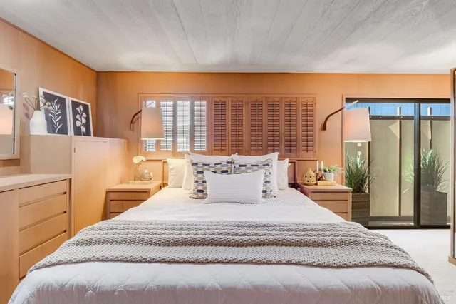 a living room with furniture and a floor to ceiling window