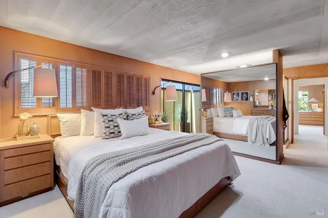 a spacious bedroom with a bed and large window