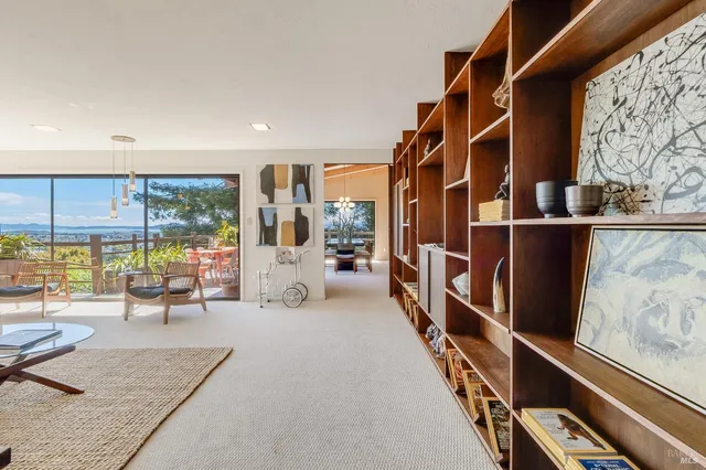 a living room with furniture and a floor to ceiling window