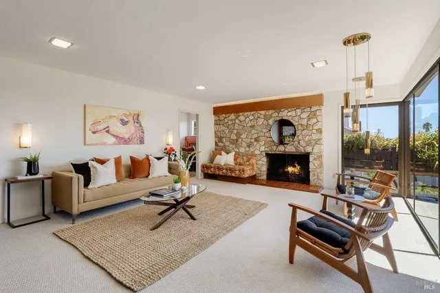 a living room with furniture gym equipment and a large window