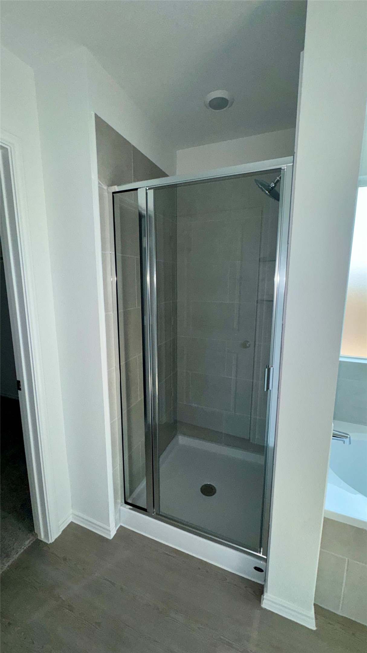 1541 Boggy Crk Rnch Road Georgetown, TX 78628 - Photo 10 of 30 Full bathroom featuring a bath, a stall shower, and wood finished floors