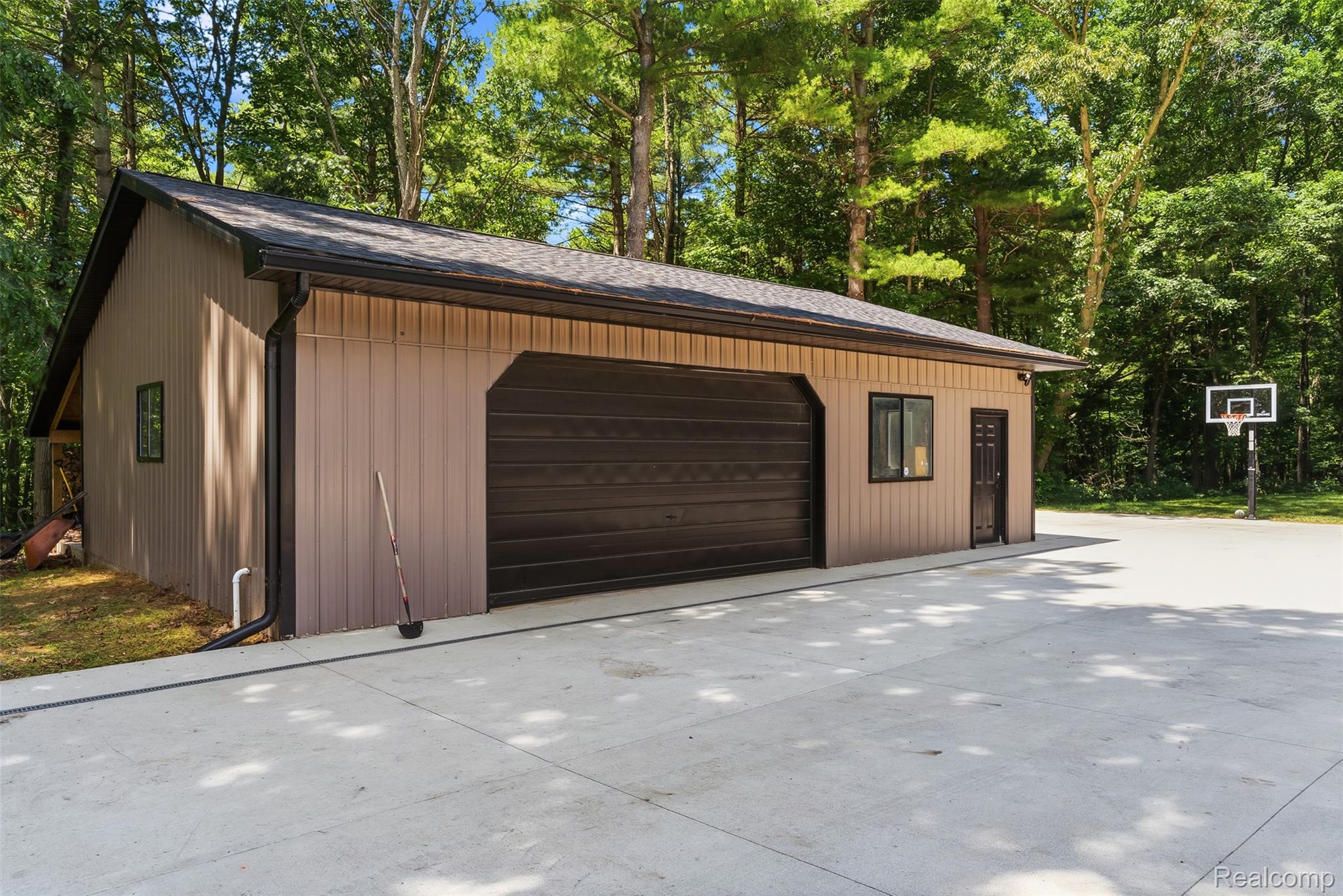 3656 Stanley Road Columbiaville, MI 48421 - Photo 4 of 65 Detached garage structure featuring light brown siding and a dark brown garage door
