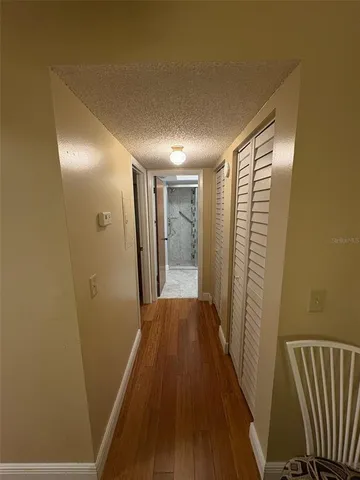 a view of hallway with wooden floor