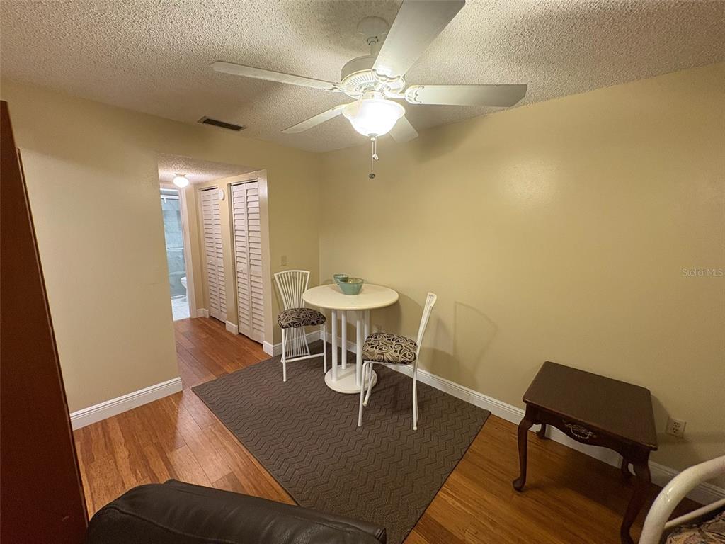 1250 South Pinellas Avenue, Unit 411 Tarpon Springs, FL 34689 - Photo 15 of 29 a view of a dining room with furniture and wooden floor