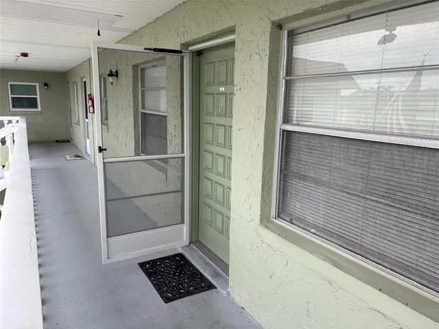 a kitchen with stainless steel appliances a refrigerator and wooden floor