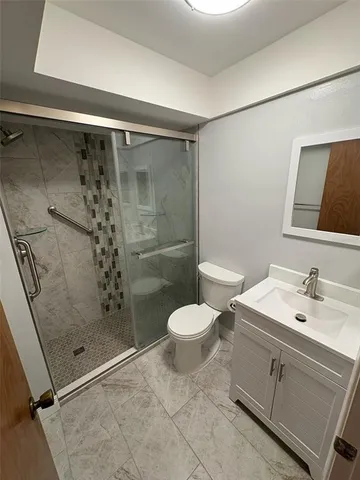 a bathroom with a shower sink and toilet