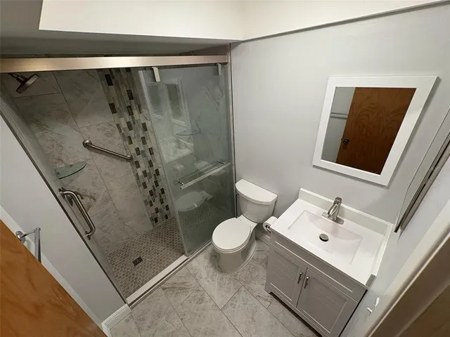 a bathroom with a shower and a toilet