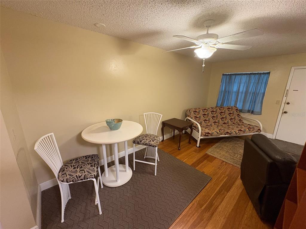 1250 South Pinellas Avenue, Unit 411 Tarpon Springs, FL 34689 - Photo 5 of 29 a view of a dining room with furniture and wooden floor