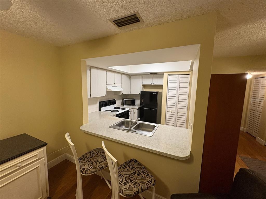 1250 South Pinellas Avenue, Unit 411 Tarpon Springs, FL 34689 - Photo 7 of 29 a view of a workspace with furniture and a window