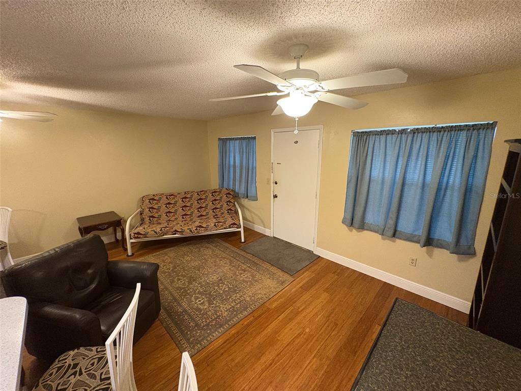 1250 South Pinellas Avenue, Unit 411 Tarpon Springs, FL 34689 - Photo 8 of 29 a bedroom with a bed and ceiling fan