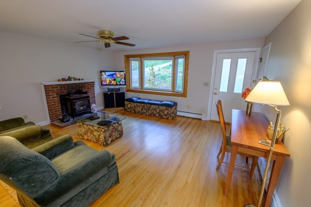 52 Summer Hill Road Maynard, MA 01754 - Photo 8 of 30 a living room with furniture and a flat screen tv with wooden floor