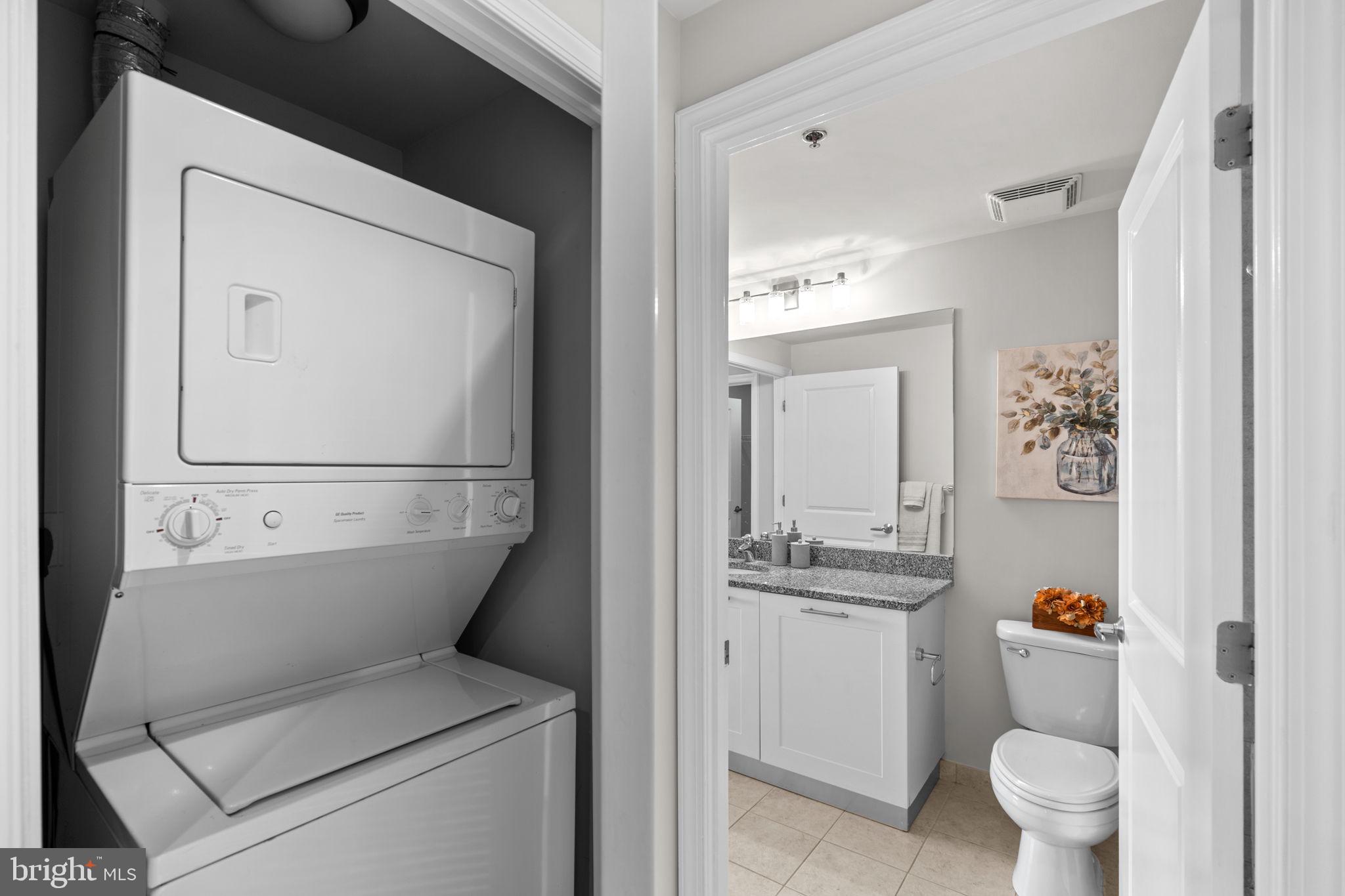 5750 Bou Avenue, Unit 1106 North Bethesda, MD 20852 - Photo 11 of 54 a bathroom with a sink and mirror with toilet