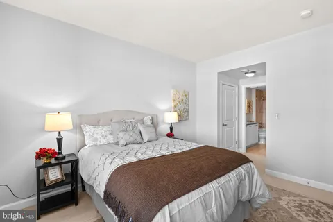 a bedroom with a bed and a lamp