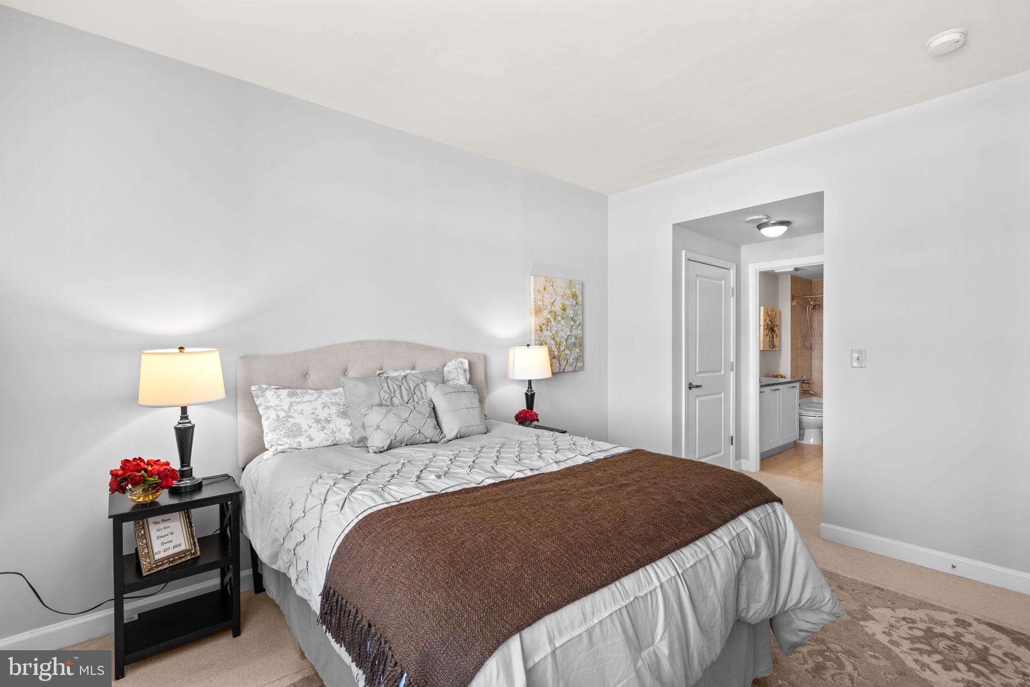 5750 Bou Avenue, Unit 1106 North Bethesda, MD 20852 - Photo 16 of 54 a bedroom with a bed and a lamp