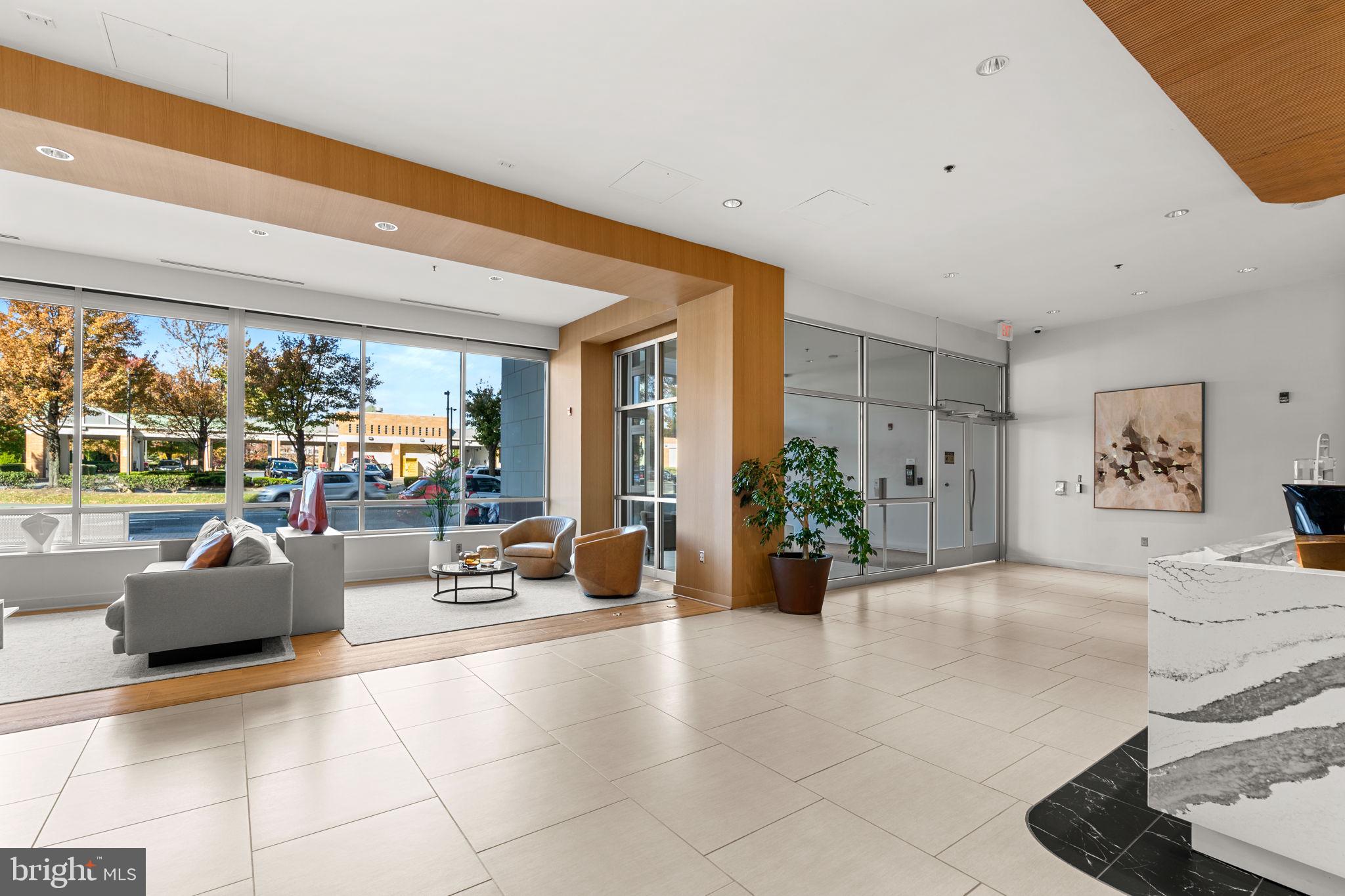 5750 Bou Avenue, Unit 1106 North Bethesda, MD 20852 - Photo 20 of 54 a view of a lobby with furniture and floor to ceiling window