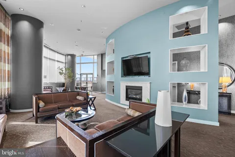 a large kitchen with a large counter top space a sink stainless steel appliances and windows