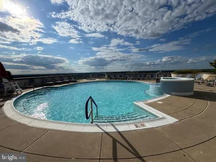 a view of a swimming pool with furniture