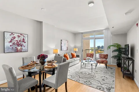 a living room with furniture potted plant and a table