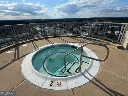 a view of swimming pool with outdoor seating and yard in back