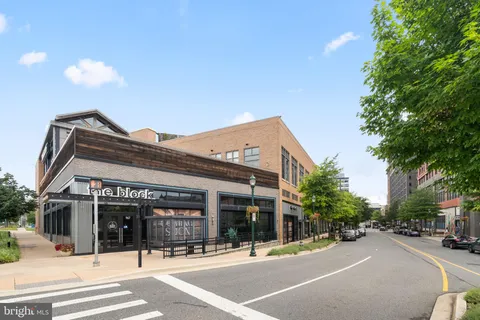 a view of a patio with a table and chairs and potted plants