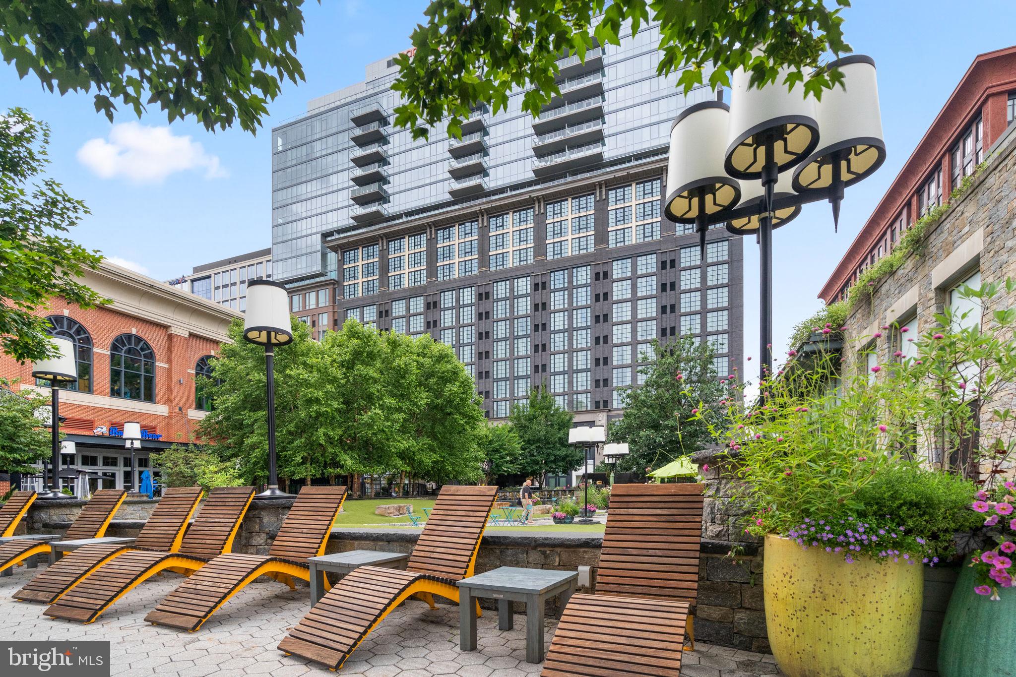 5750 Bou Avenue, Unit 1106 North Bethesda, MD 20852 - Photo 40 of 54 a view of a patio with a table and chairs and potted plants