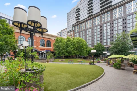 a view of a building with a garden and sitting area