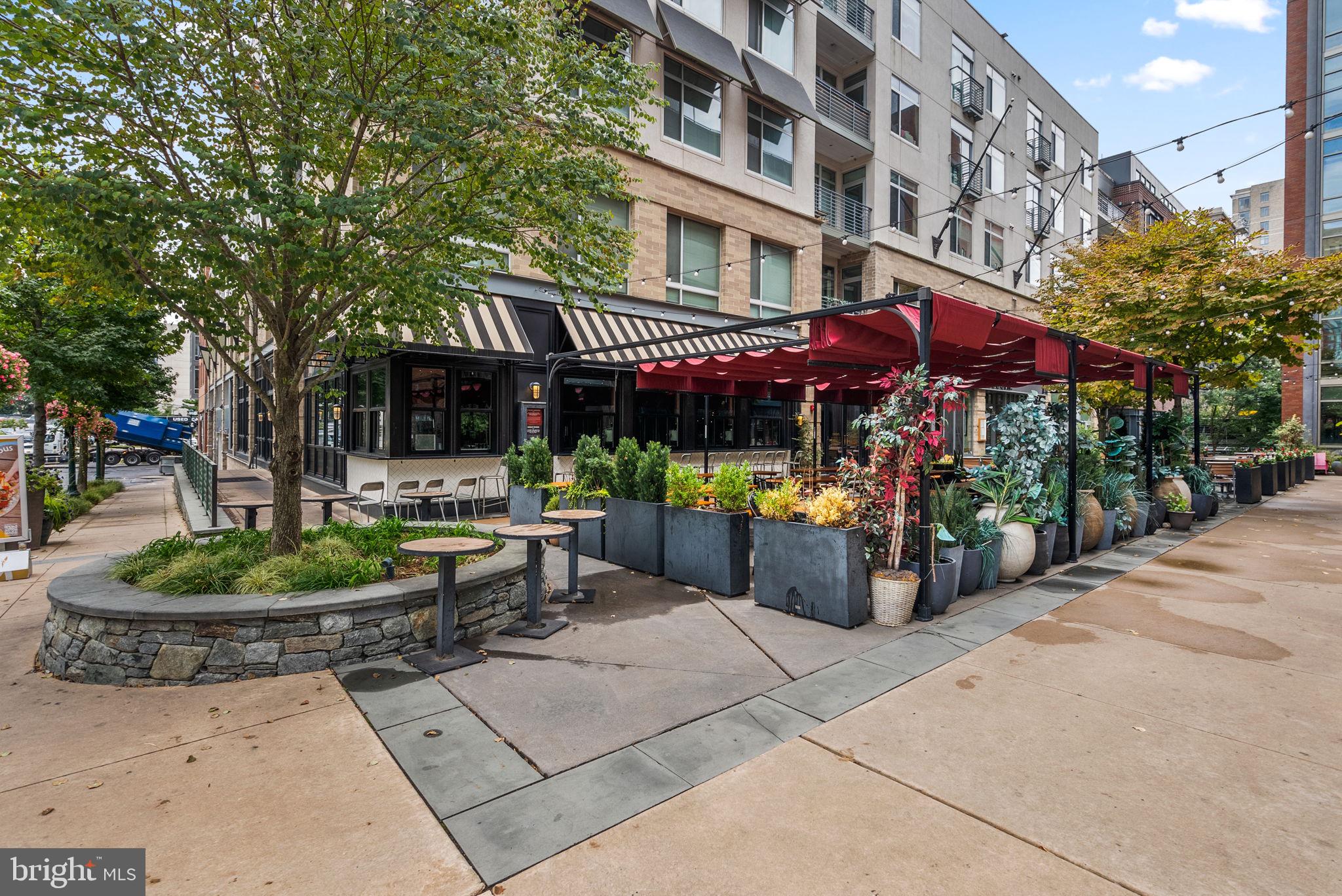 5750 Bou Avenue, Unit 1106 North Bethesda, MD 20852 - Photo 45 of 54 a view of a cafe with a table and chairs under an umbrella