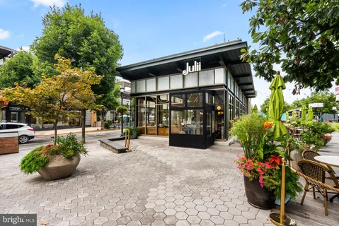 a view of a patio with table and chairs under an umbrella