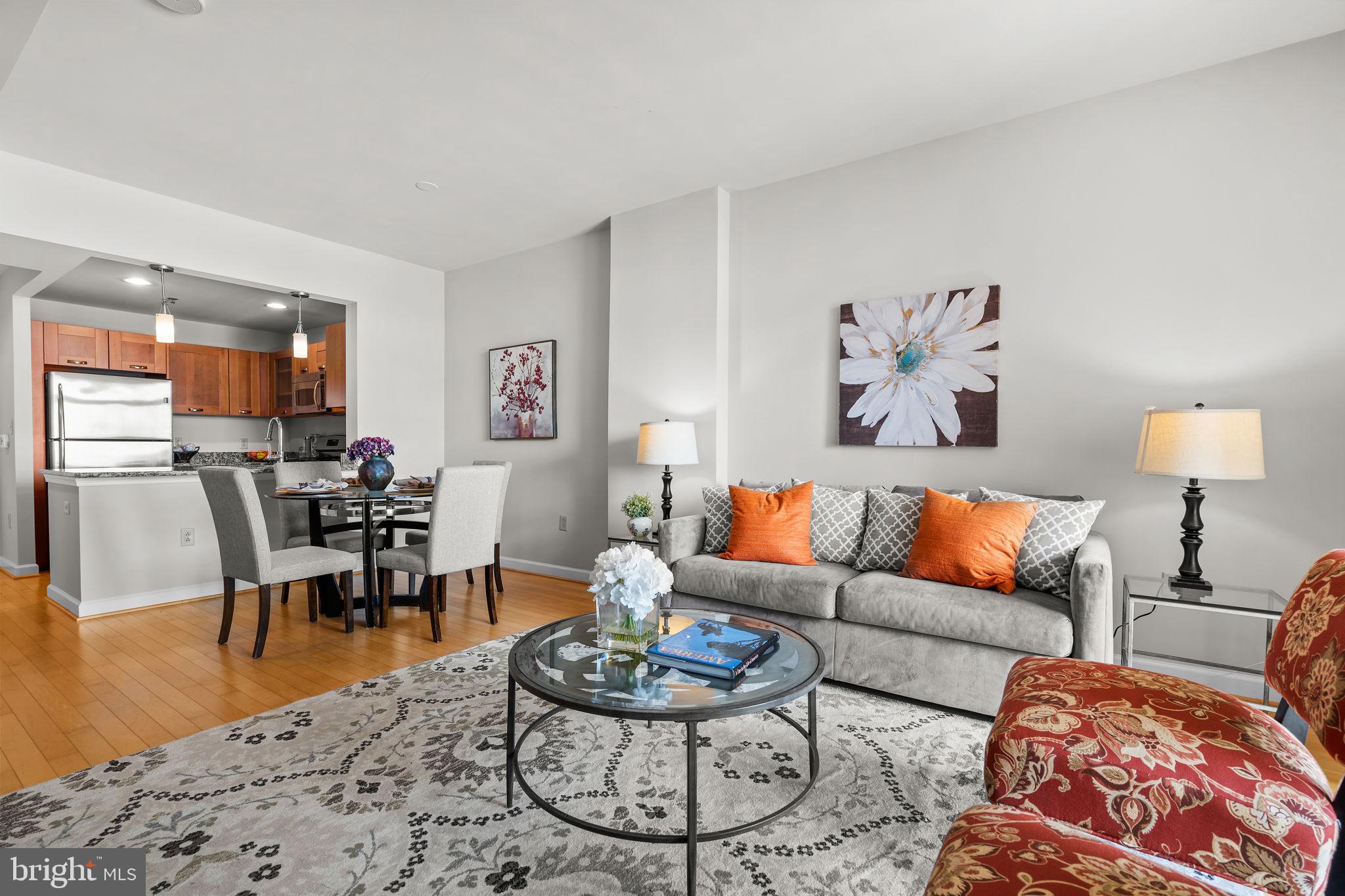 5750 Bou Avenue, Unit 1106 North Bethesda, MD 20852 - Photo 5 of 54 a living room with furniture and wooden floor