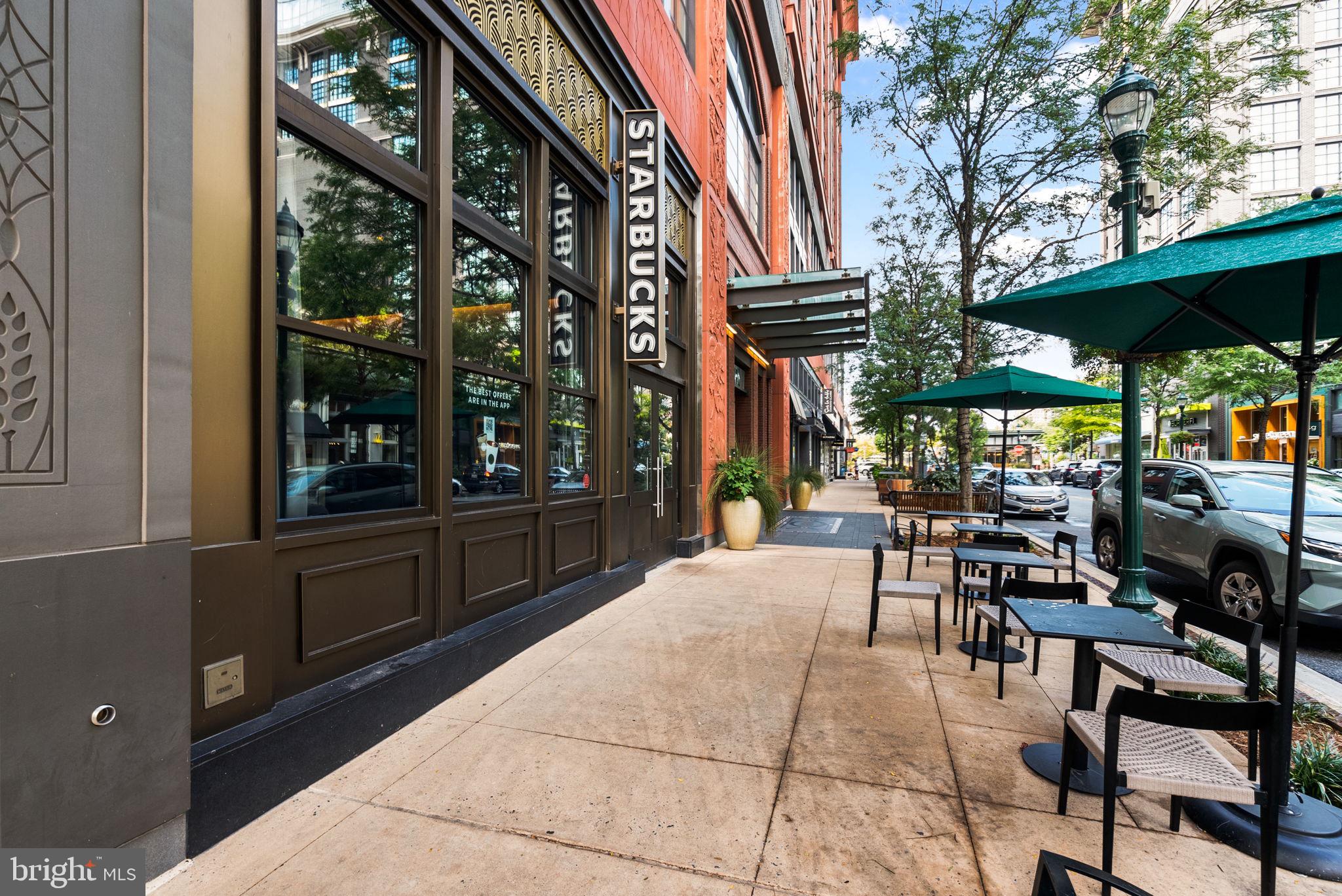 5750 Bou Avenue, Unit 1106 North Bethesda, MD 20852 - Photo 53 of 54 a view of a patio with table and chairs under an umbrella