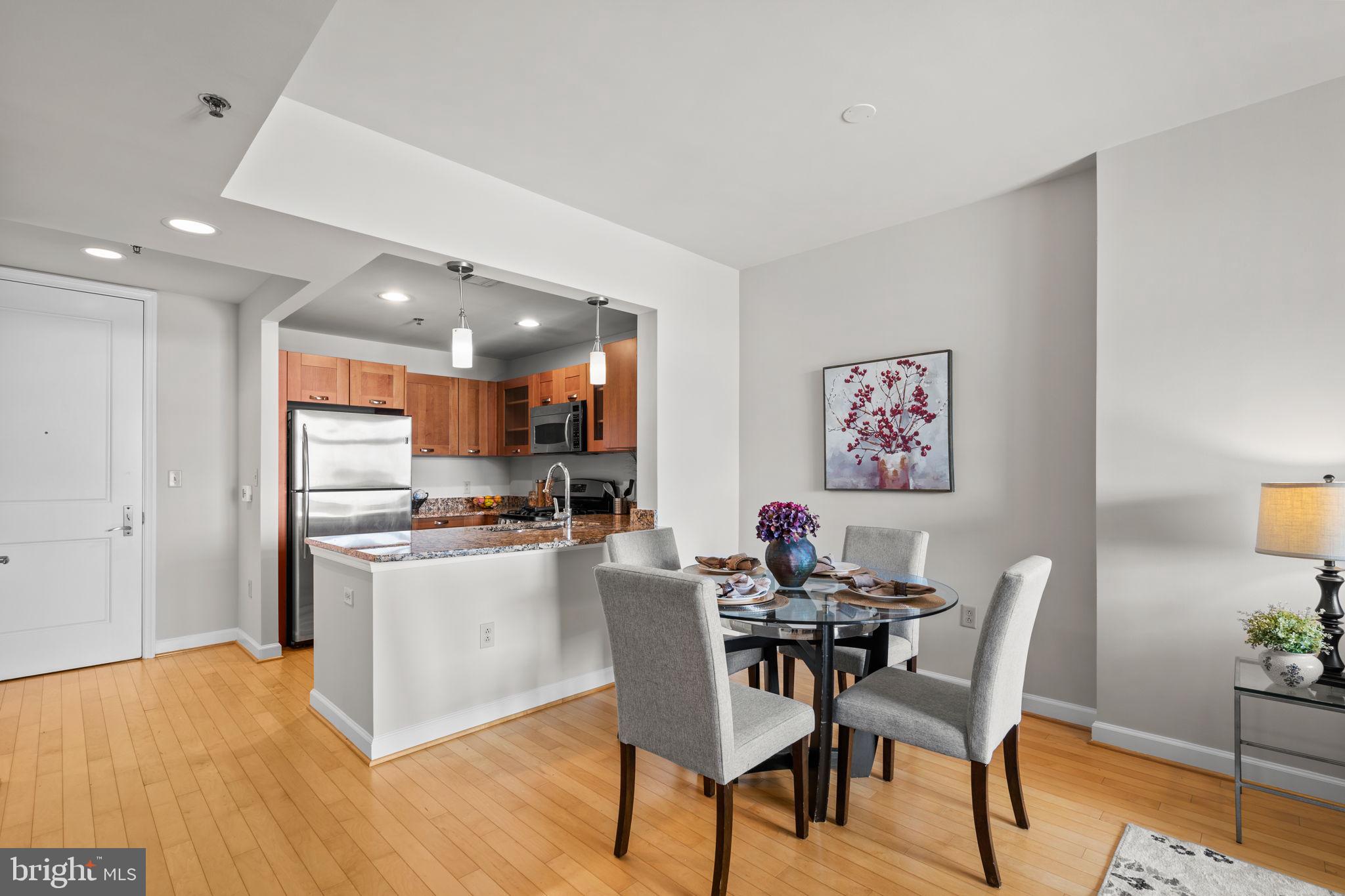 5750 Bou Avenue, Unit 1106 North Bethesda, MD 20852 - Photo 6 of 54 a view of a dining room with furniture and wooden floor