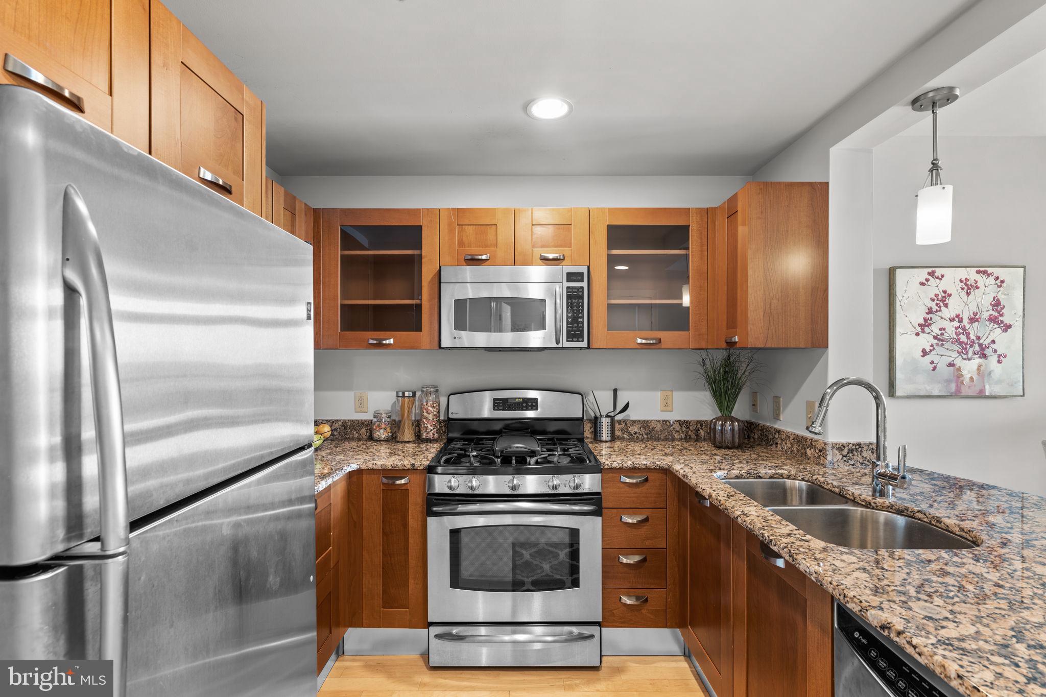 5750 Bou Avenue, Unit 1106 North Bethesda, MD 20852 - Photo 8 of 54 a kitchen with stainless steel appliances granite countertop a sink stove and refrigerator