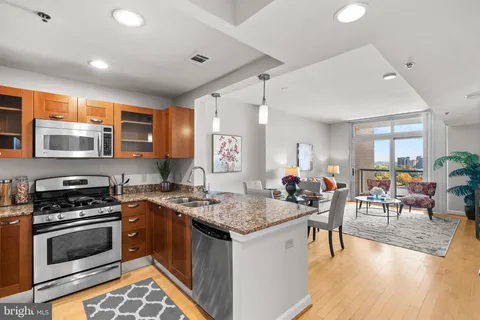 a kitchen with stainless steel appliances granite countertop a stove and a sink