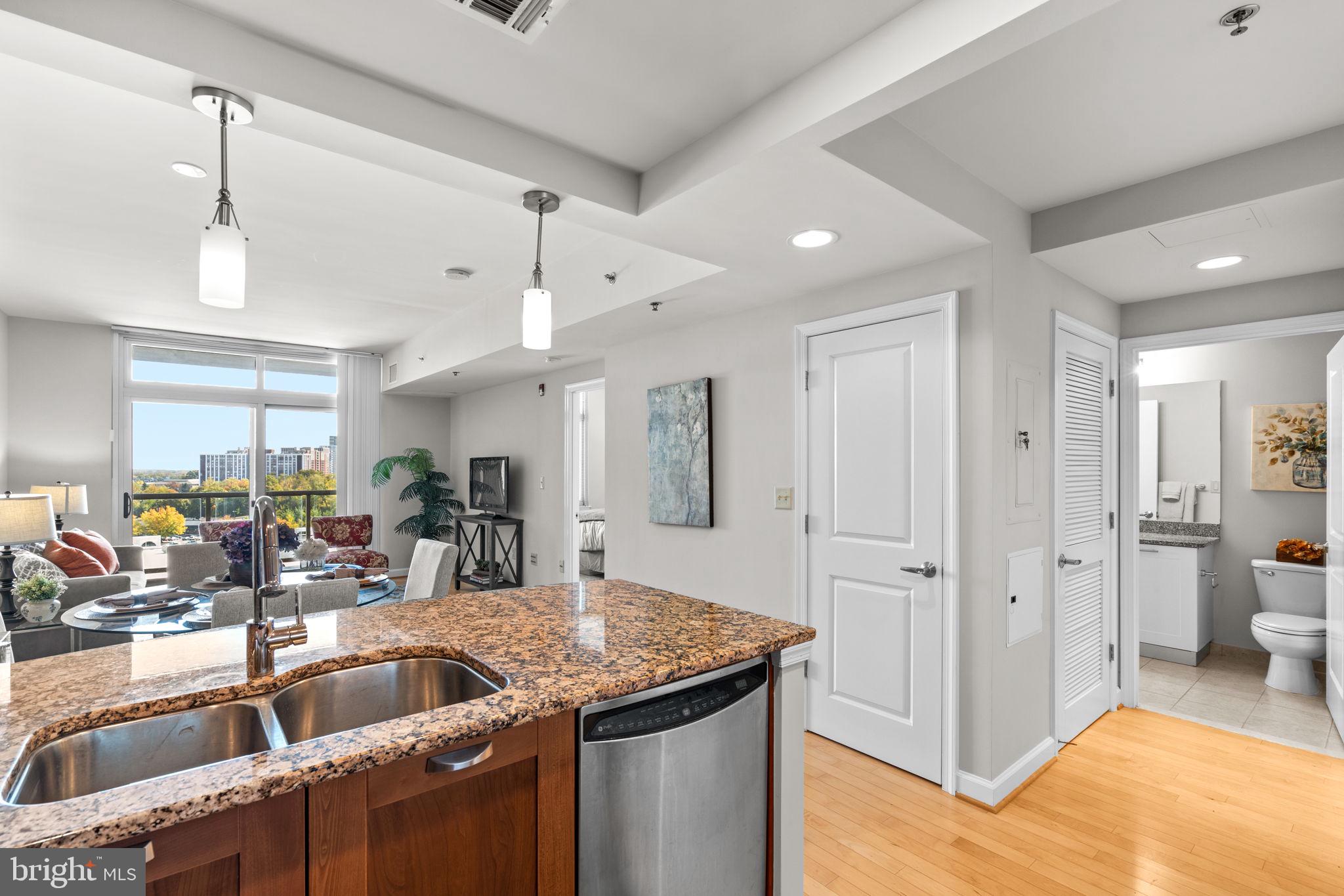 5750 Bou Avenue, Unit 1106 North Bethesda, MD 20852 - Photo 10 of 54 a kitchen view with stainless steel appliances granite countertop a sink and a refrigerator