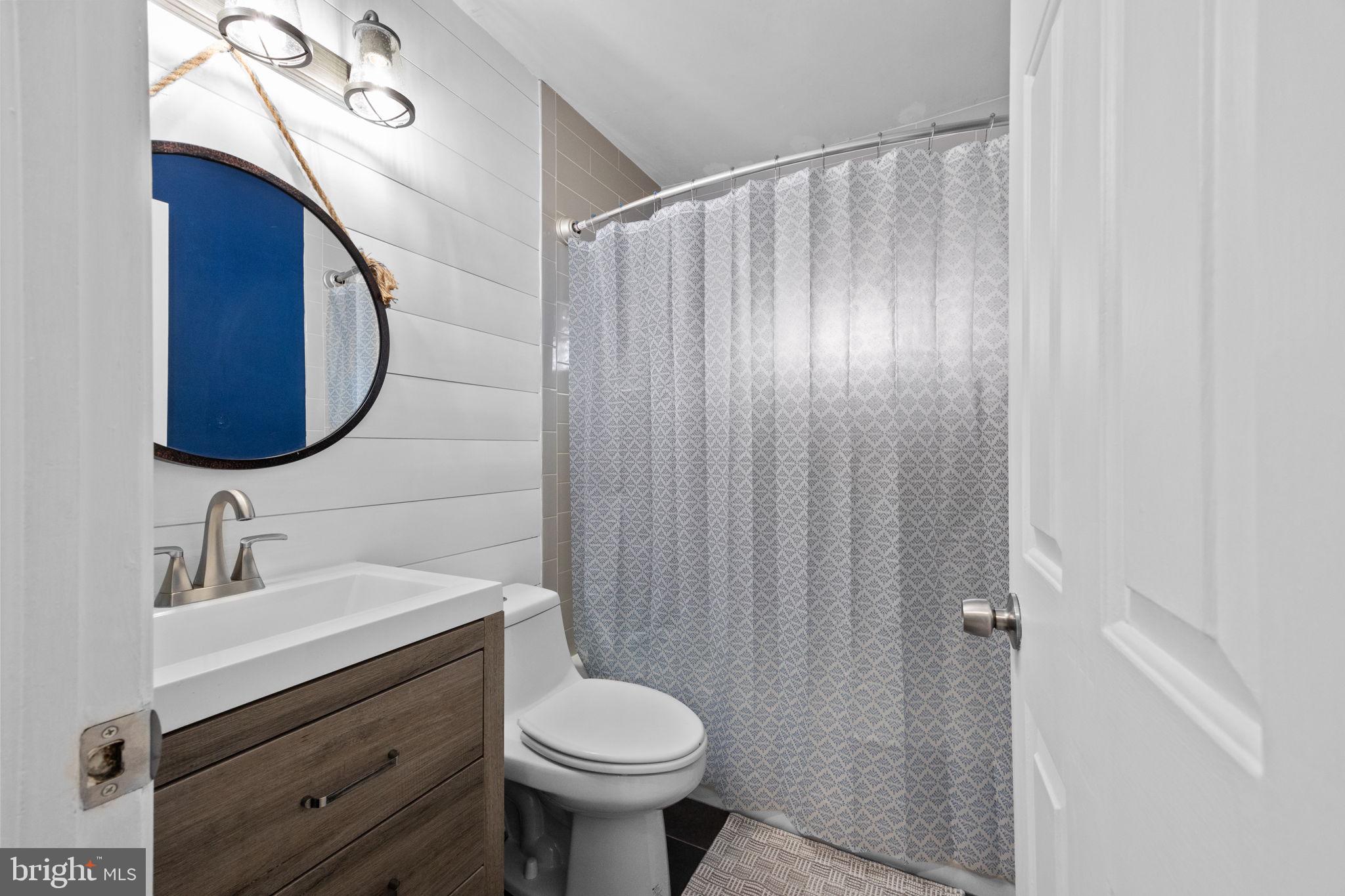 19 Violet Road Levittown, PA 19057 - Photo 14 of 26 a bathroom with a sink and a mirror