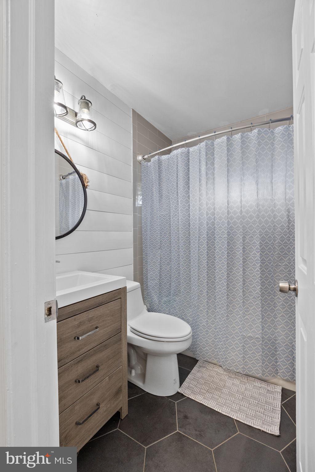 19 Violet Road Levittown, PA 19057 - Photo 15 of 26 a bathroom with a toilet a sink and a shower