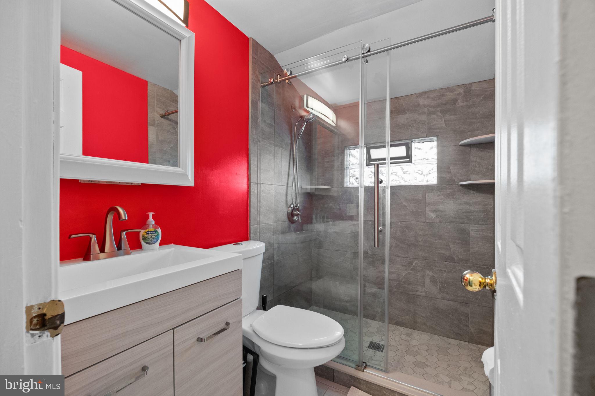 19 Violet Road Levittown, PA 19057 - Photo 17 of 26 a bathroom with a toilet sink vanity and shower