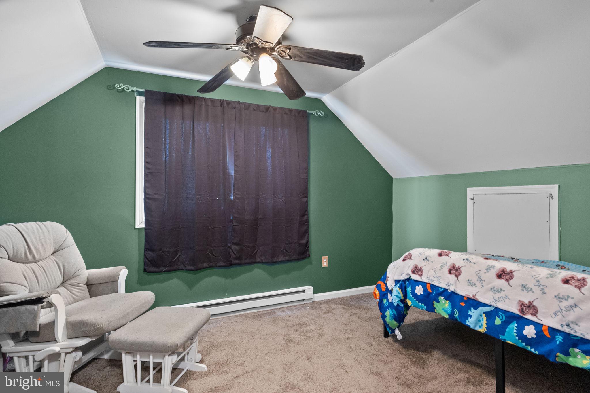 19 Violet Road Levittown, PA 19057 - Photo 21 of 26 a bedroom with a bed and a chandelier