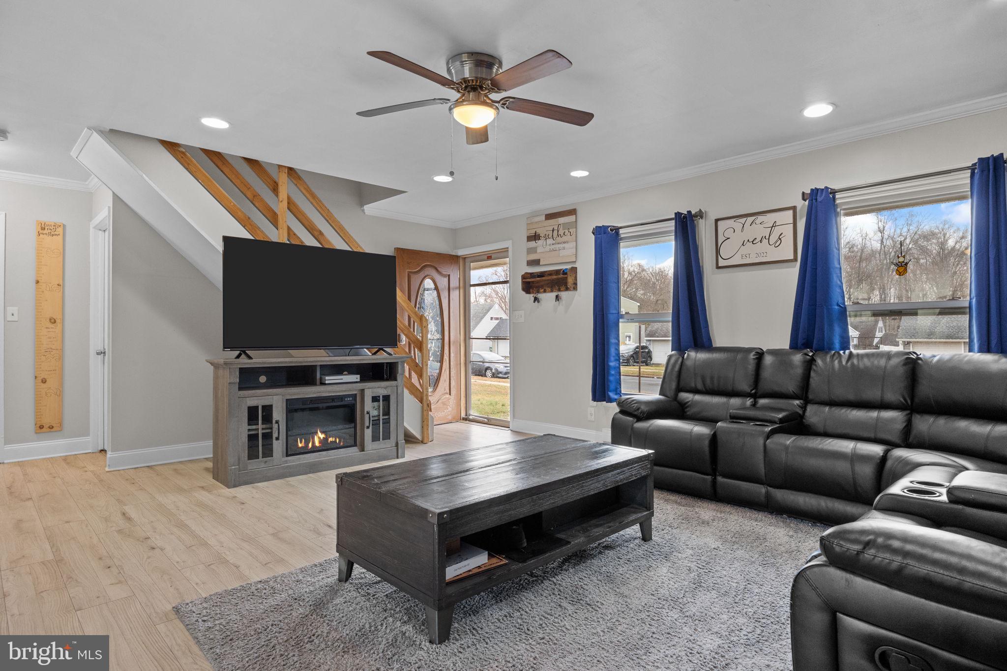 19 Violet Road Levittown, PA 19057 - Photo 6 of 26 a living room with furniture a flat screen tv and a large window
