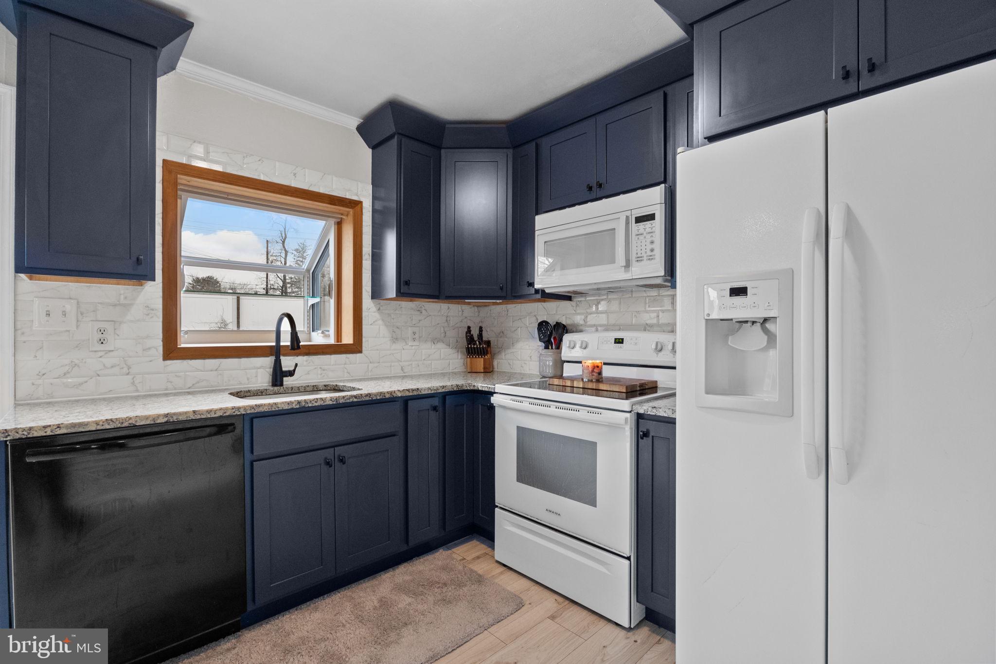 19 Violet Road Levittown, PA 19057 - Photo 8 of 26 a kitchen with white cabinets and white appliances