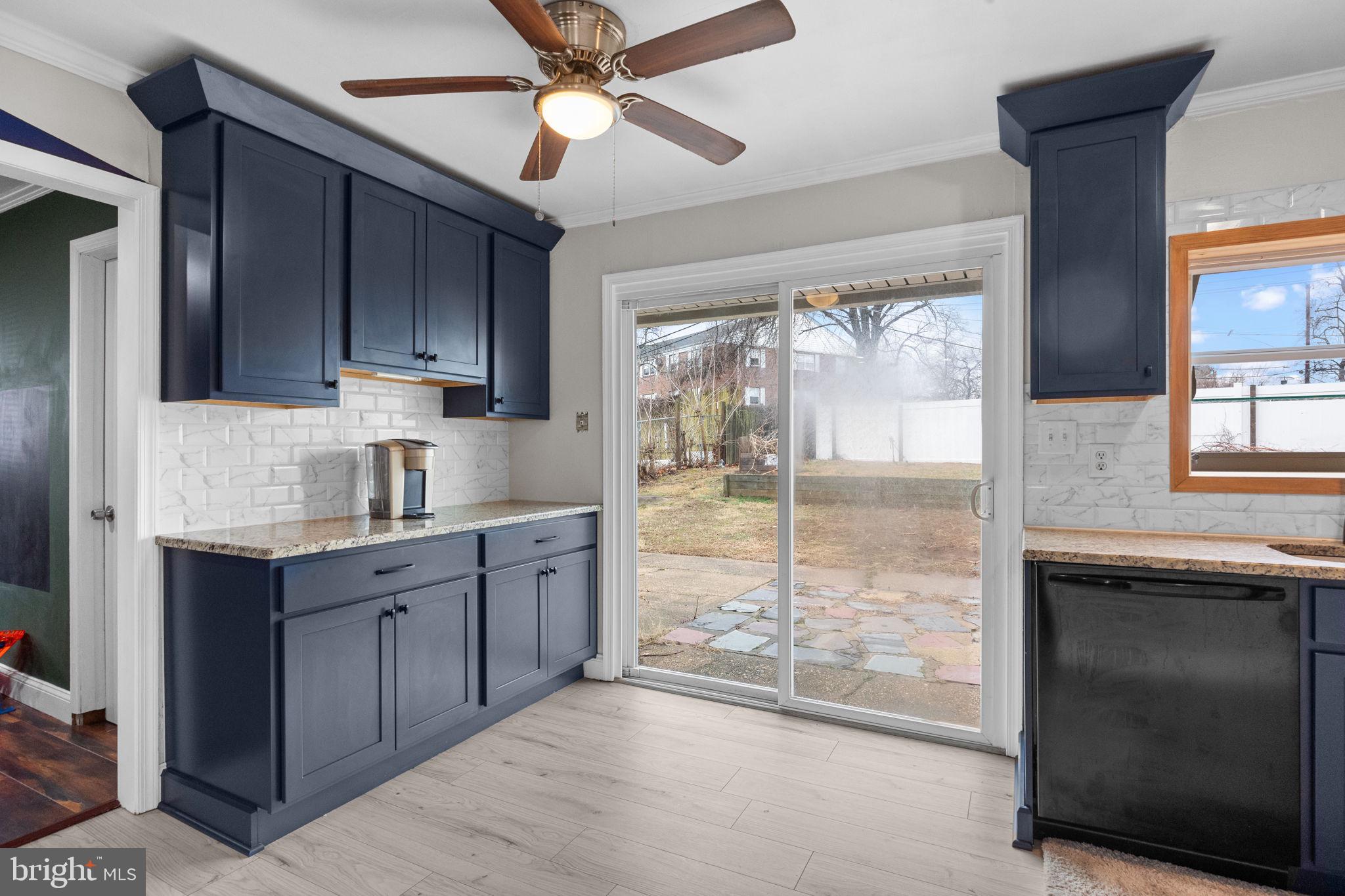 19 Violet Road Levittown, PA 19057 - Photo 9 of 26 a kitchen with kitchen island granite countertop a refrigerator a sink a stove and cabinets