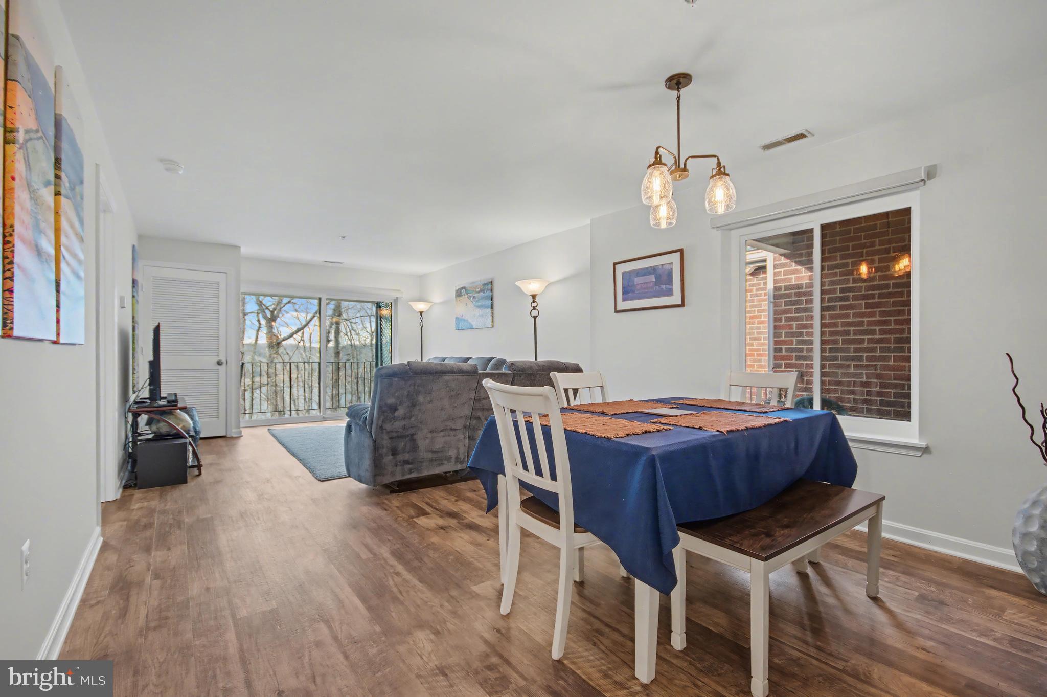 2900 Shipmaster Way, Unit 312 Annapolis, MD 21401 - Photo 11 of 56 a dining room with furniture window wooden floor