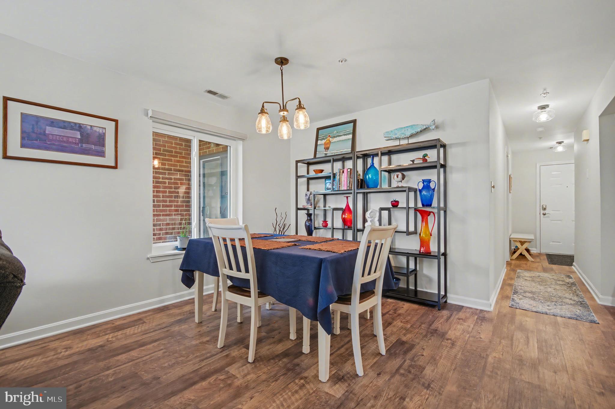 2900 Shipmaster Way, Unit 312 Annapolis, MD 21401 - Photo 12 of 56 a view of a dining room with furniture window and wooden floor